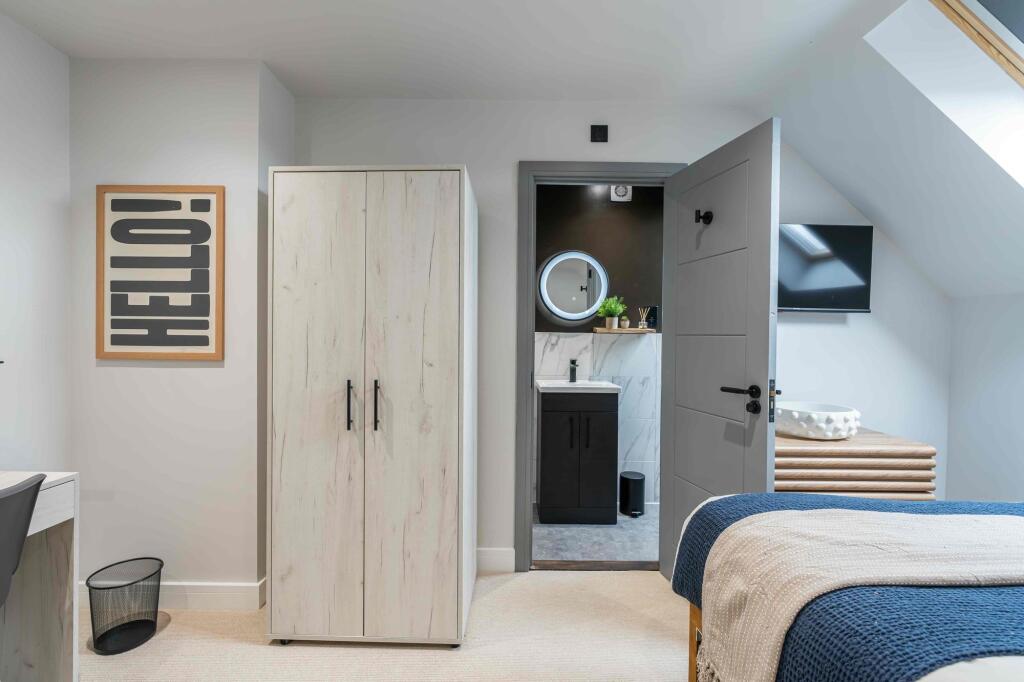 A bright and modern bedroom featuring a stylish...