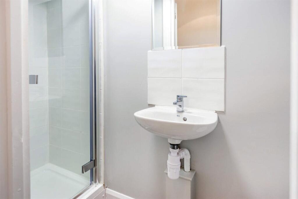 This modern bathroom features a sleek shower wi...