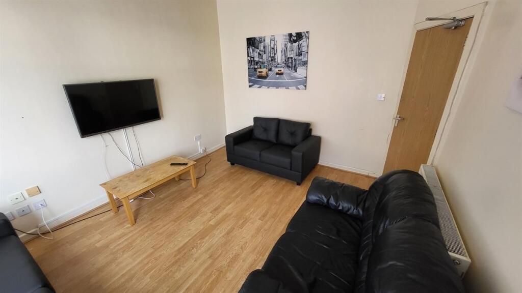 Cozy living room featuring comfortable black so...
