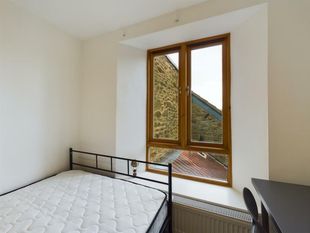 A bright and inviting double bedroom with large...