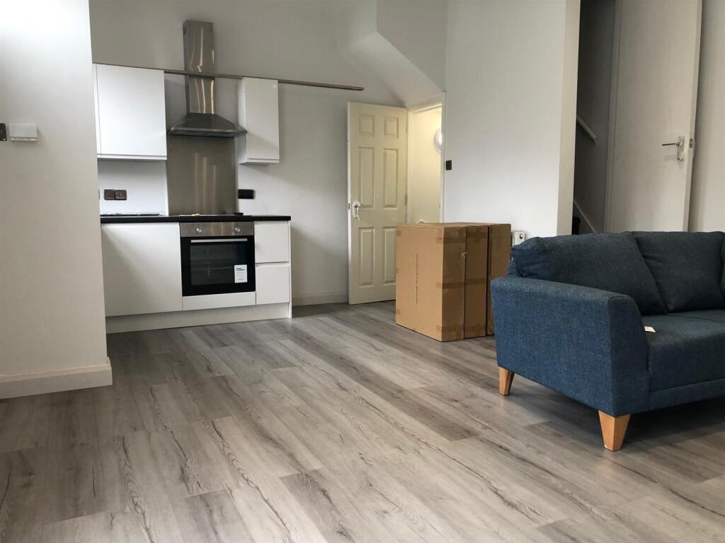 A modern, well-maintained living room with ampl...