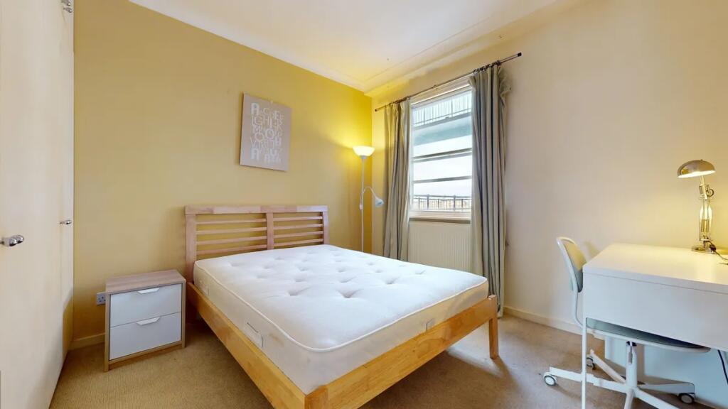 Bright and cozy double bedroom featuring a comf...