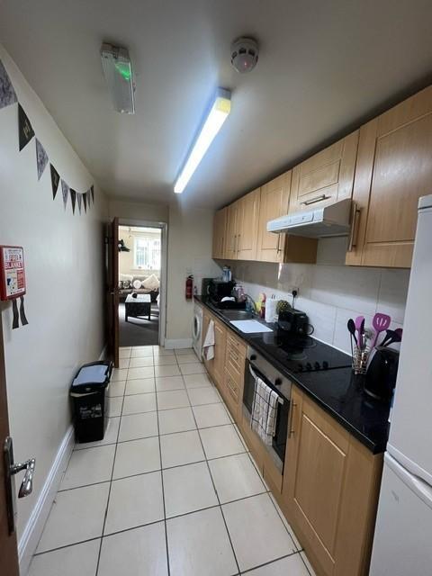 A tidy and modern kitchen with ample storage ca...