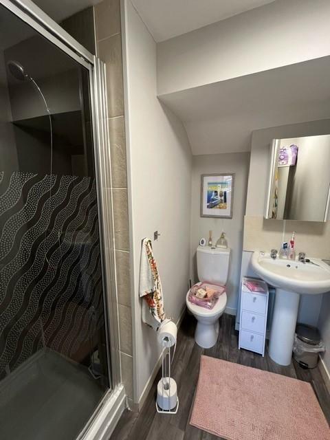 Well-kept bathroom with a walk-in shower, pedes...