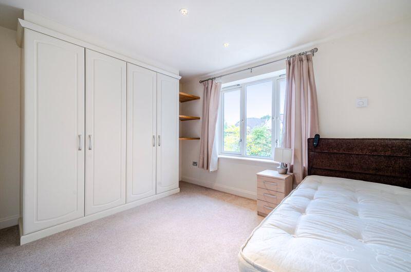 Bedroom with fitted wardrobes and ens...