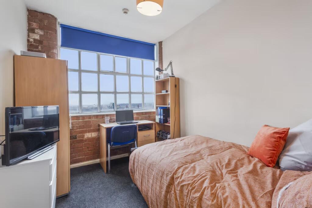 A bright and inviting double bedroom with ample...