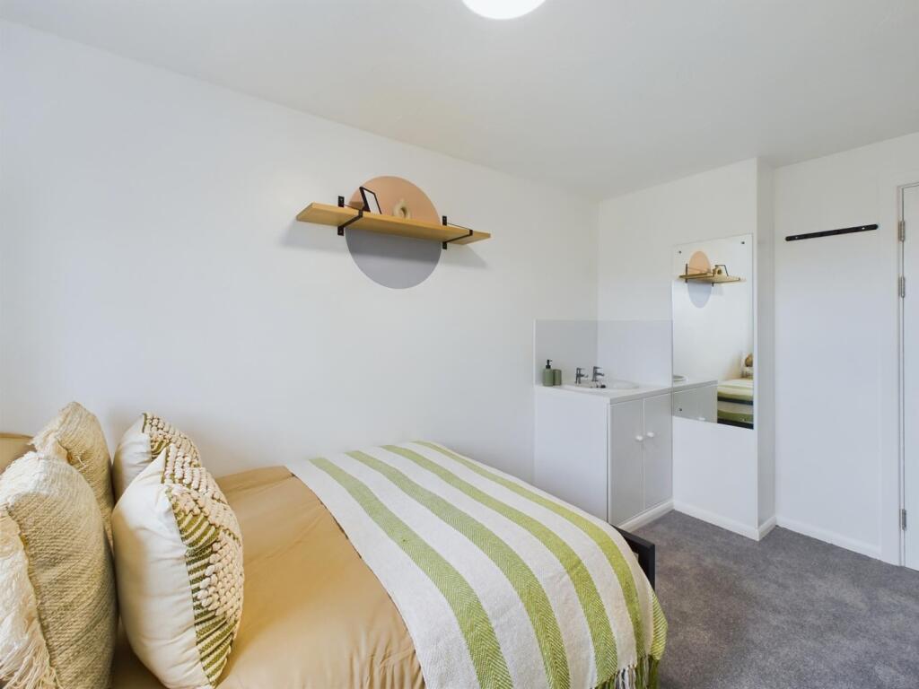 A bright and inviting double bedroom with moder...