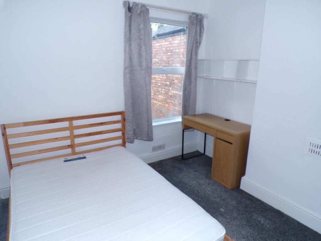A bright and tidy double bedroom featuring a co...