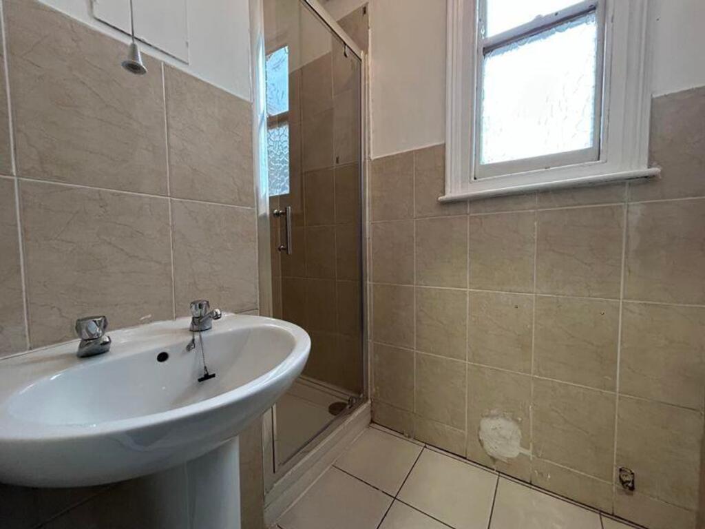 A tidy and well-maintained bathroom featuring a...