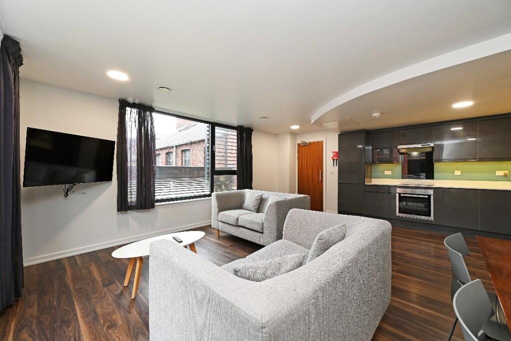 Bright and modern living room featuring comfort...