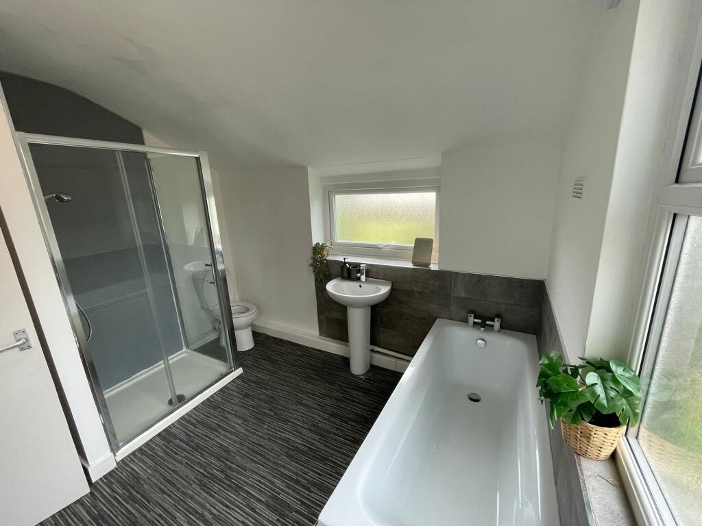 Modern bathroom featuring a spacious bathtub, a...