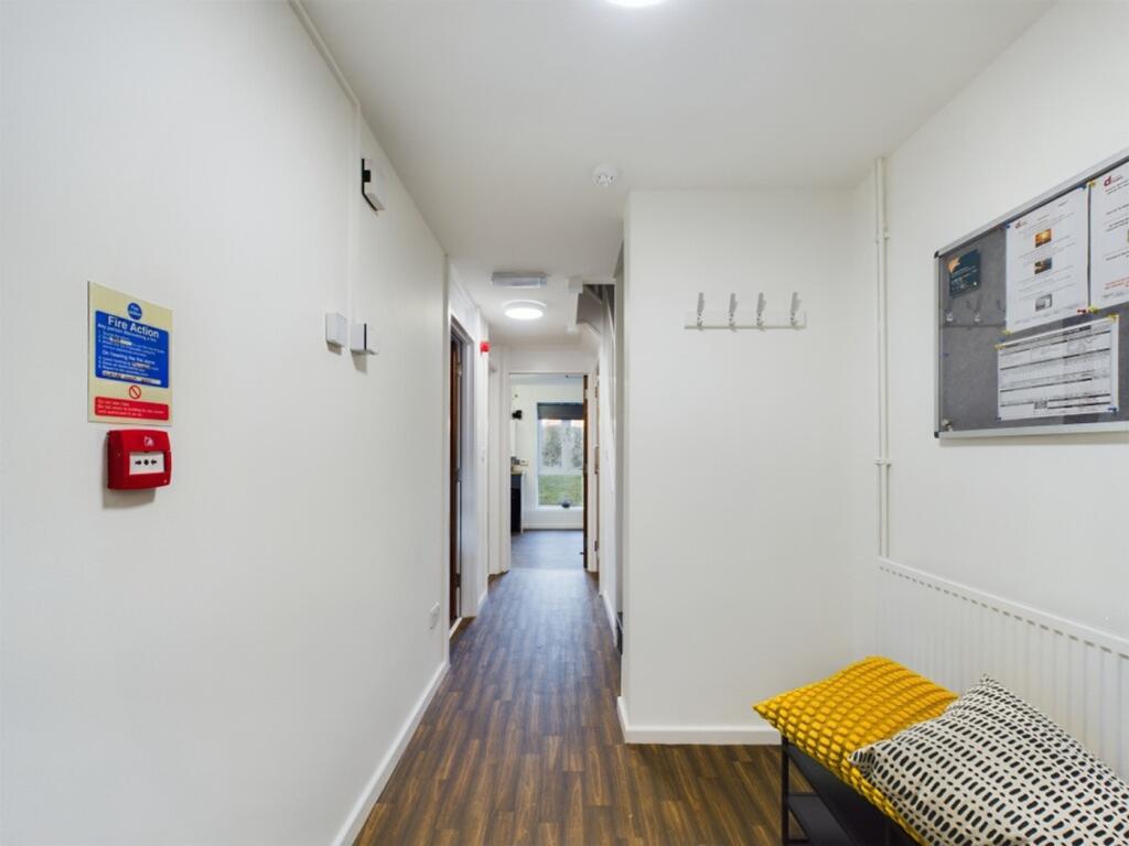 A bright and tidy hallway with modern decor, pe...
