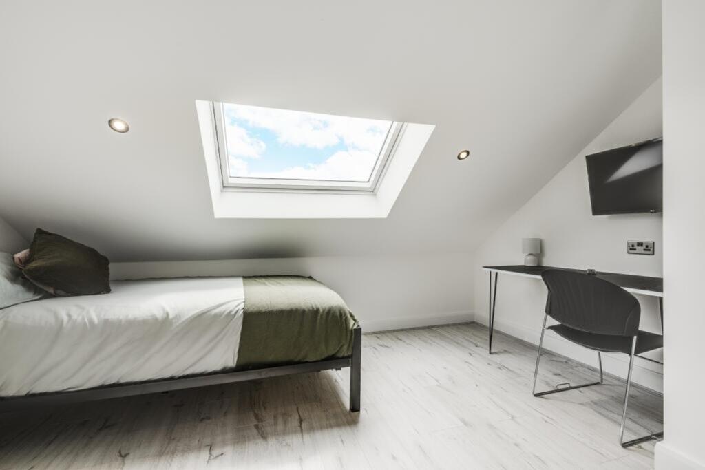 A bright and inviting double bedroom featuring ...