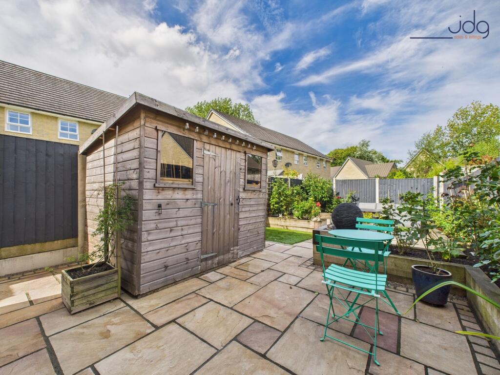 Beautifully Landscaped Garden with mixture of flags and artificial grass