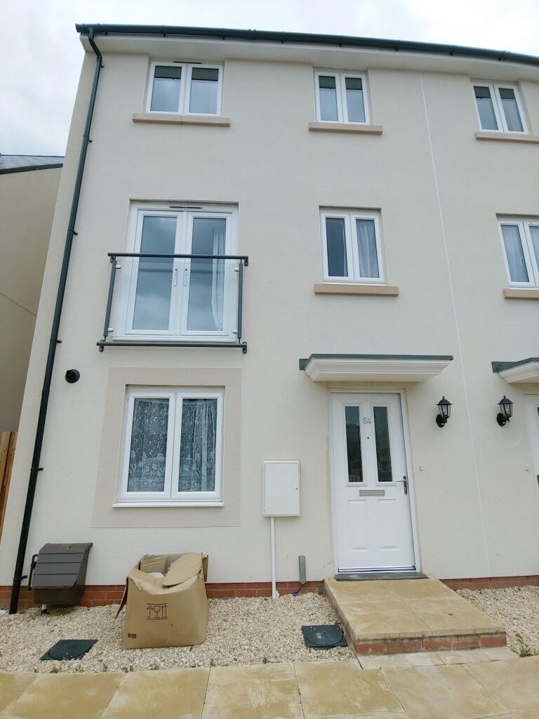 Modern three-storey terraced house with a clean...