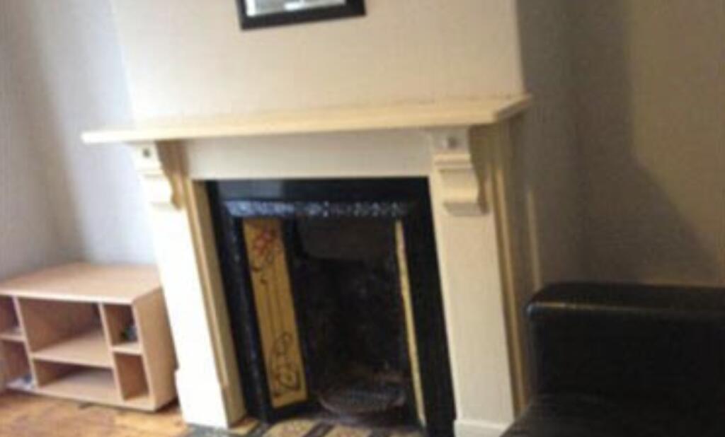 Cozy living area featuring a decorative firepla...