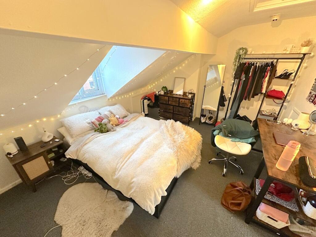 Cozy attic double bedroom with a comfy bed bene...