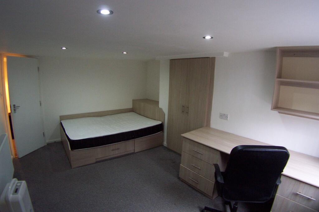 A well-maintained bedroom featuring a single be...