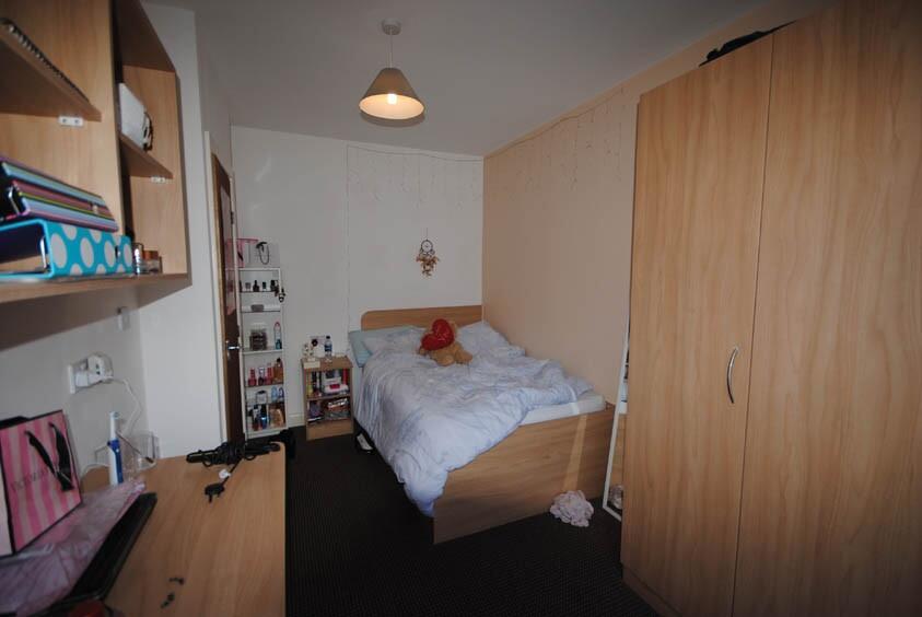 A cozy bedroom with a comfortable bed, partiall...