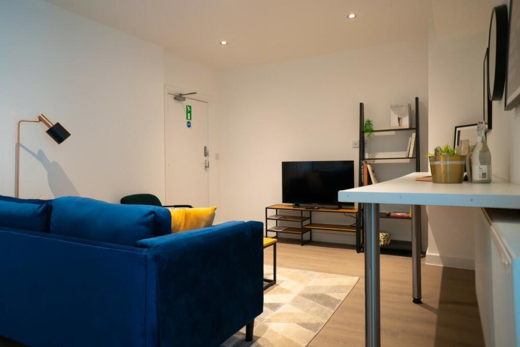 A modern, well-lit living room featuring a vibr...