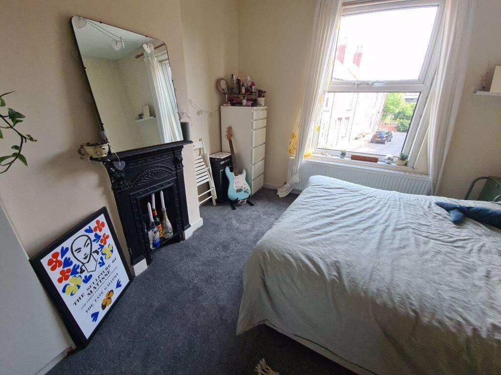A cozy and well-maintained bedroom featuring a ...