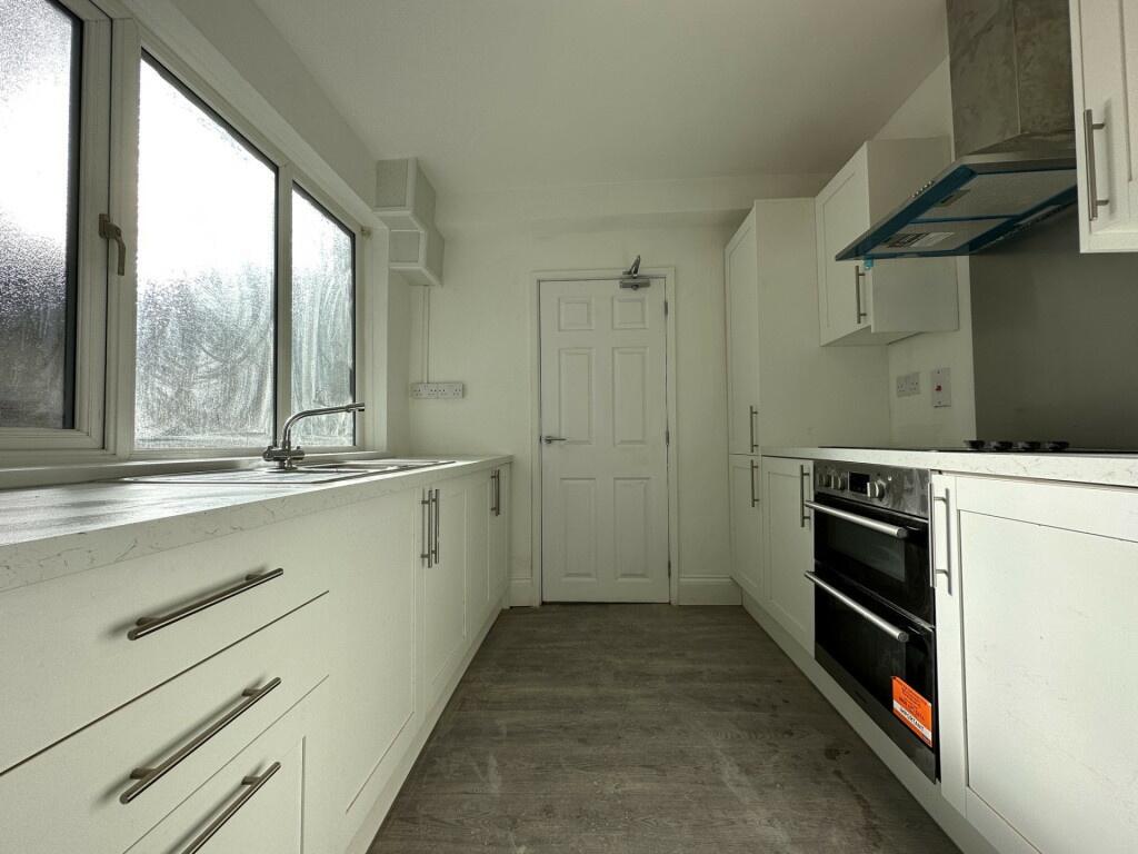 A bright and modern kitchen with ample natural ...