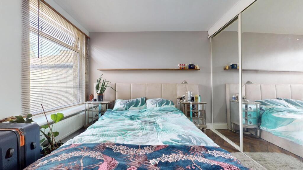 A bright and tidy double bedroom featuring a co...