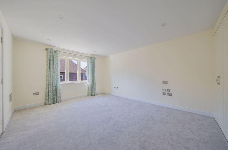 Bedroom with fitted wardrobes and ens...