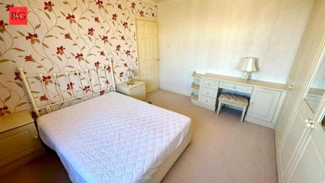 Bright and cozy double bedroom featuring a comf...