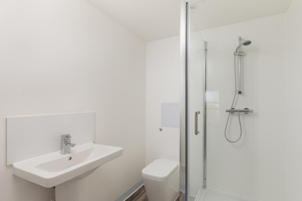 A modern and clean bathroom featuring a shower ...