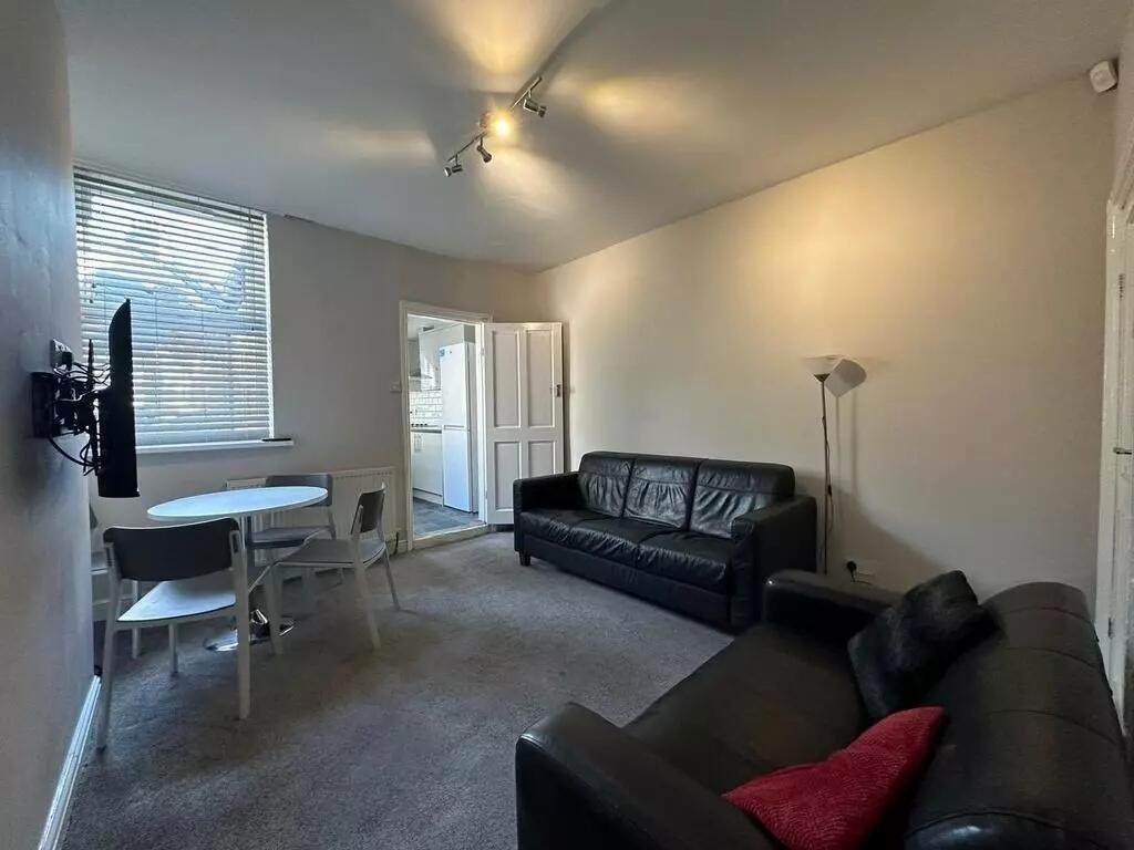 A comfortable living room featuring two black l...