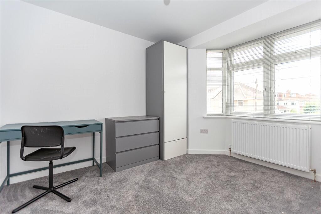 Bright and clean single bedroom featuring a lar...