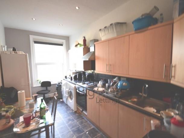 A functional kitchen featuring ample wooden cab...