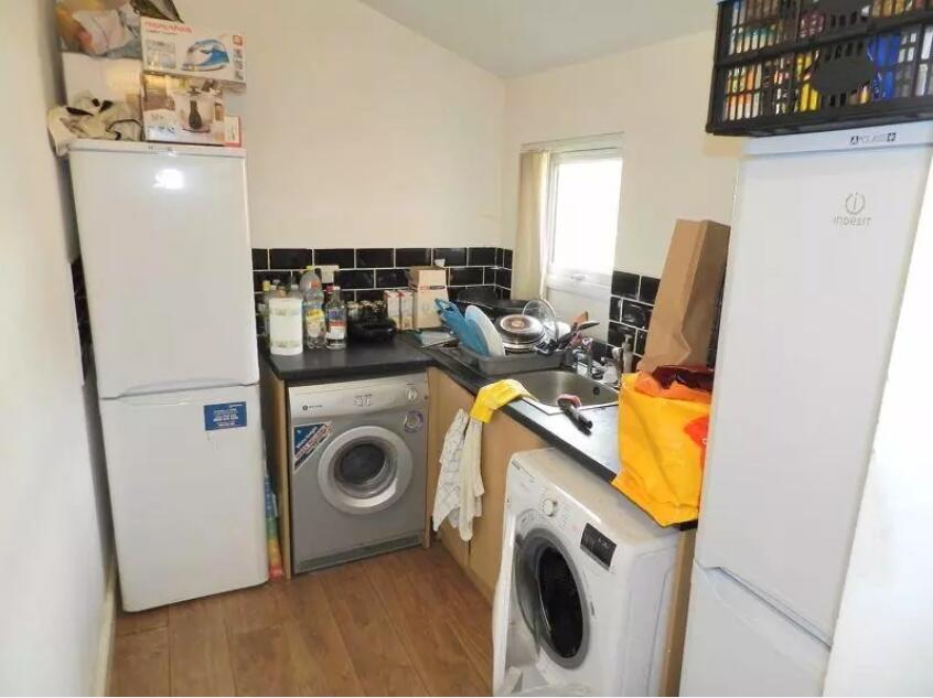 Compact kitchen area featuring modern appliance...