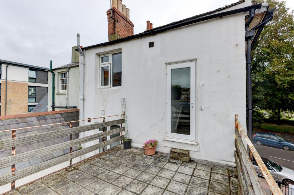Charming exterior view of a terraced house feat...