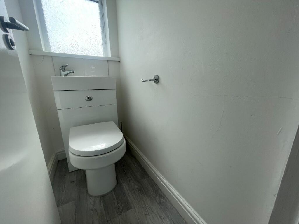 A tidy and functional single toilet with modern...