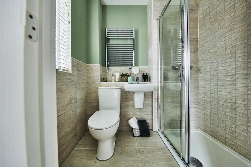 The main bedroom boasts an en-suite shower room