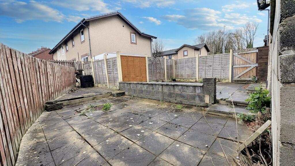 Flagged garden that wraps around the rear of the property