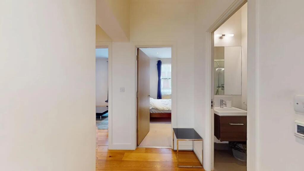 Bright and clean hallway featuring warm wooden ...