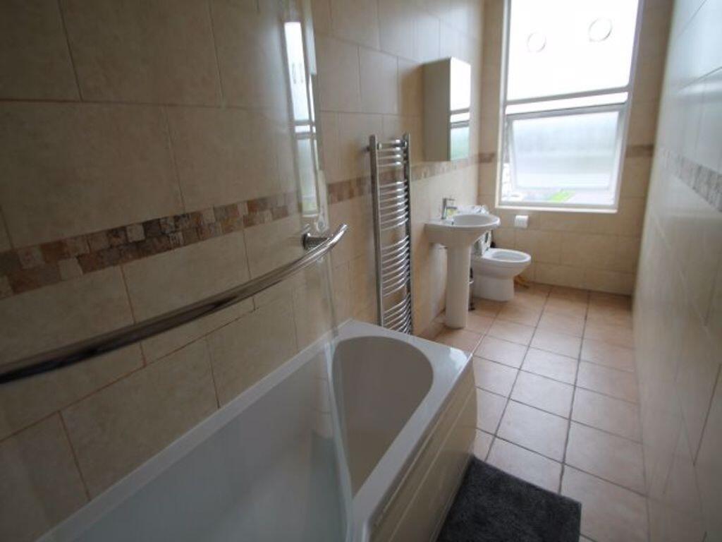 Bright and clean bathroom featuring a full-size...