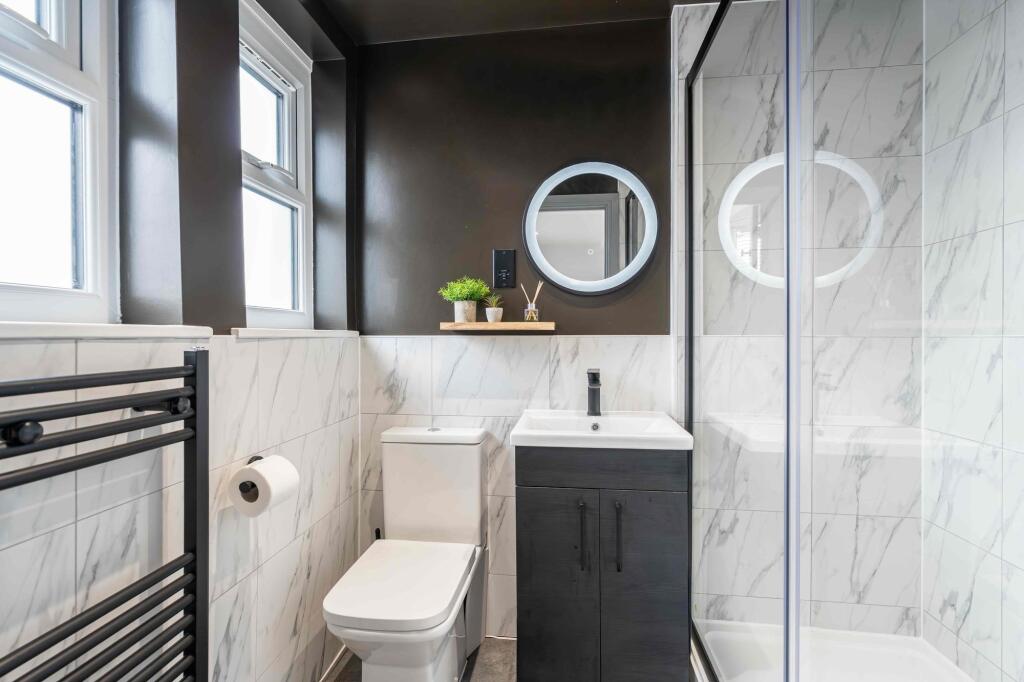 Modern and clean bathroom featuring a white toi...
