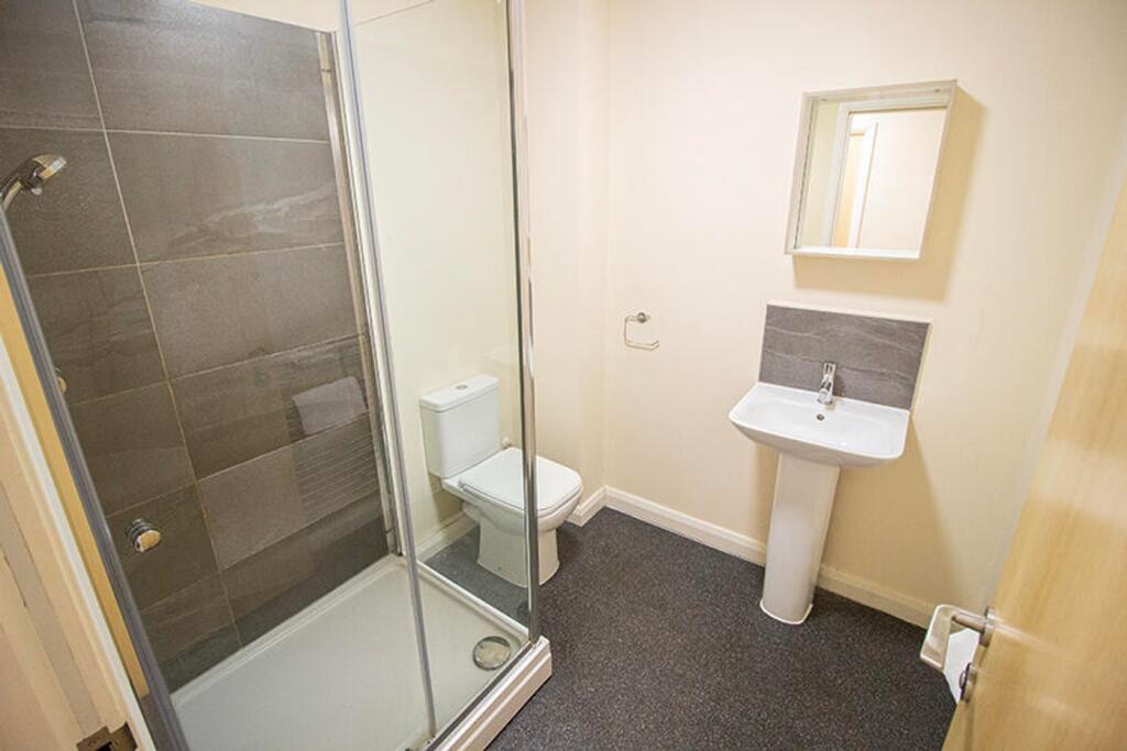 A modern bathroom featuring a sleek shower, sty...