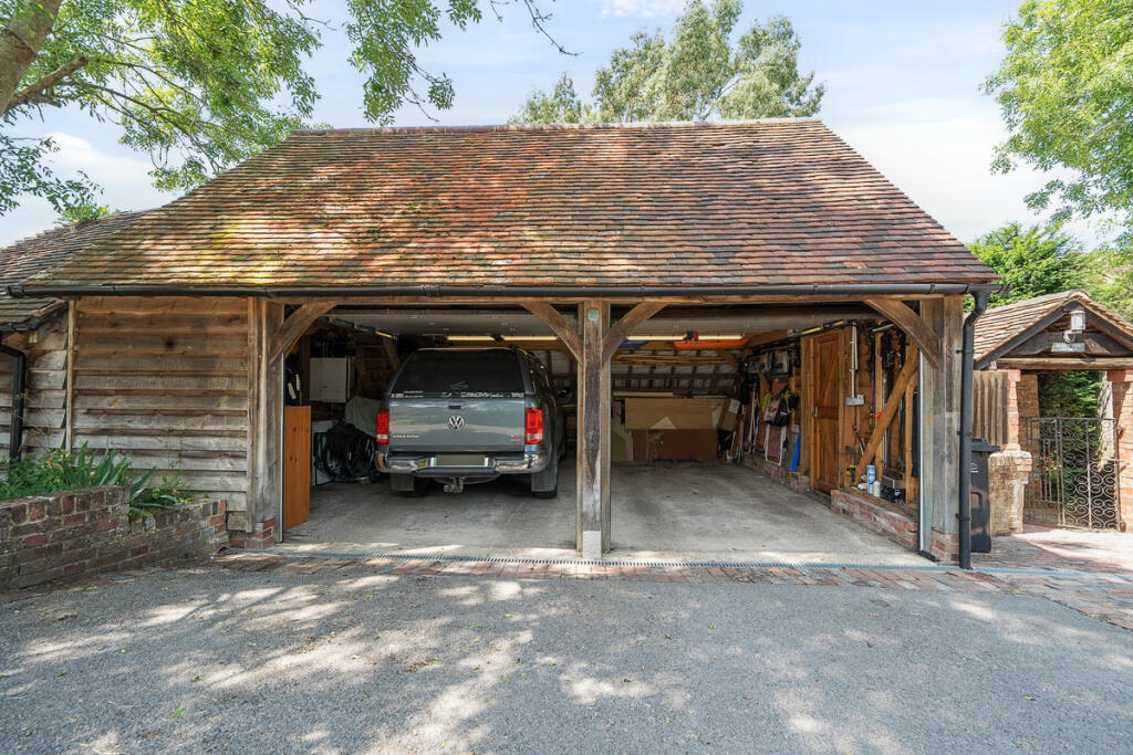 Double garage with room above and separate workshop with power, light and remote controlled roller doors