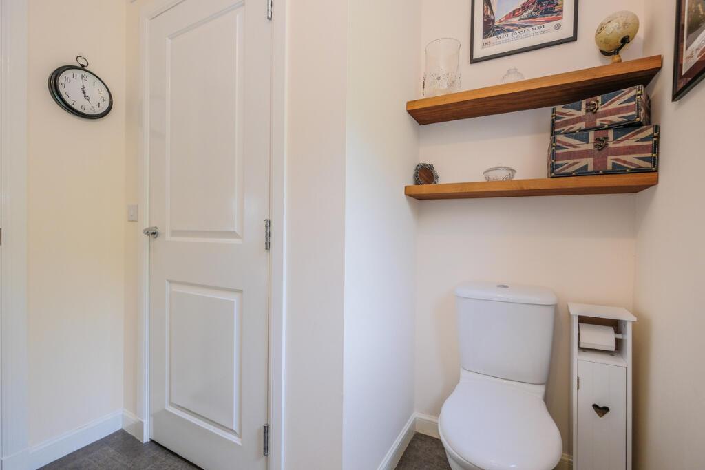 Downstairs toilet, view of utility cupboard