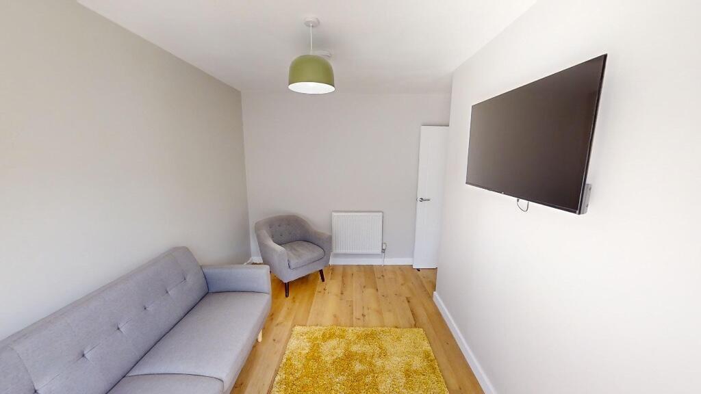 A neat and modern small living room featuring a...