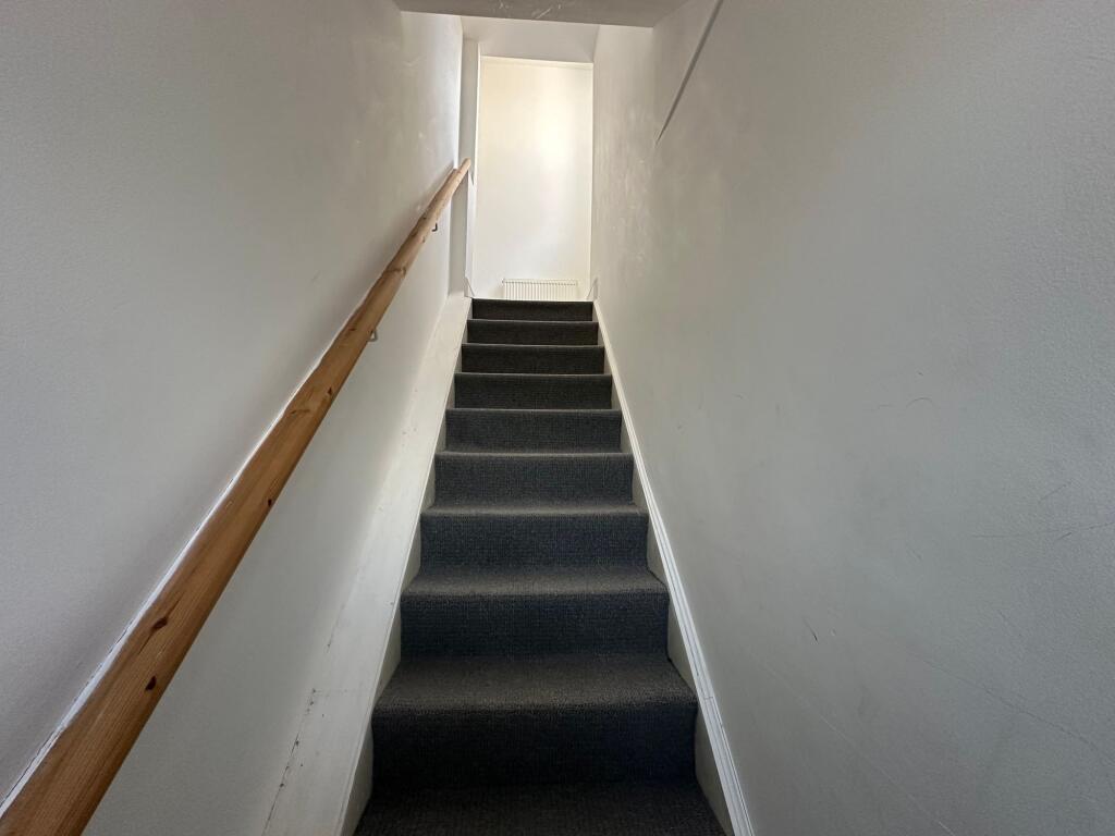 A well-maintained indoor staircase with a woode...