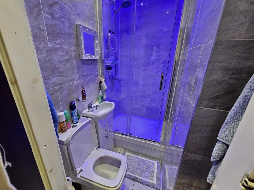 A clean and modern bathroom featuring a shower ...