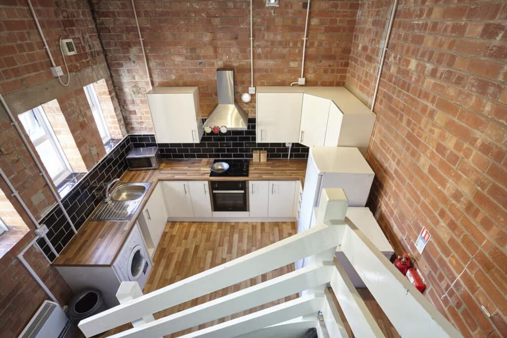 A spacious and modern kitchen with stylish wood...