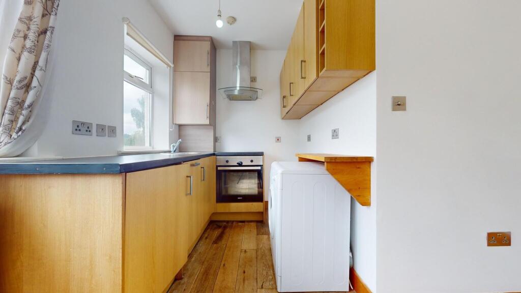 Bright and functional kitchen with ample natura...