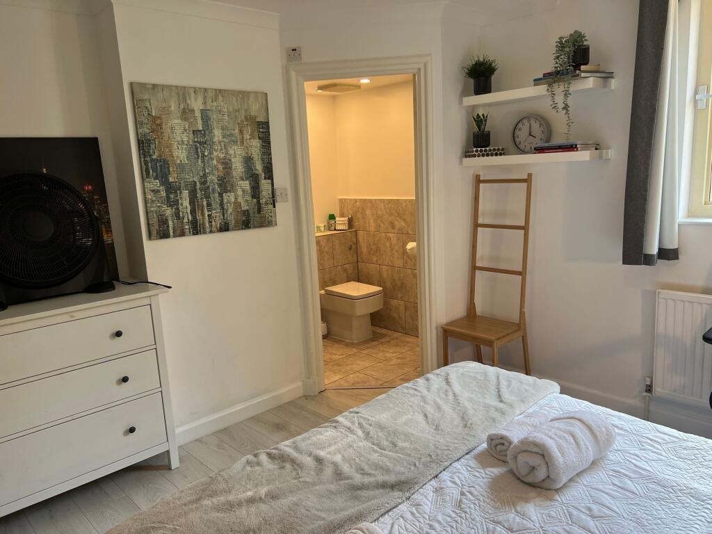 A bright and inviting master bedroom featuring ...